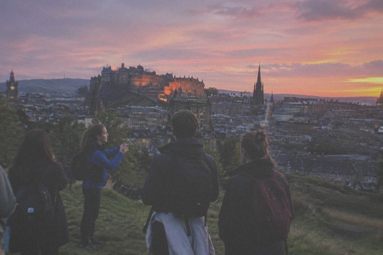 Edinburgh Castle on its volcanic rock above the city skyline at dusk