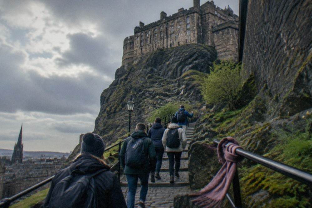 The ramparts and stone walls of Edinburgh Castle seen from below the rock