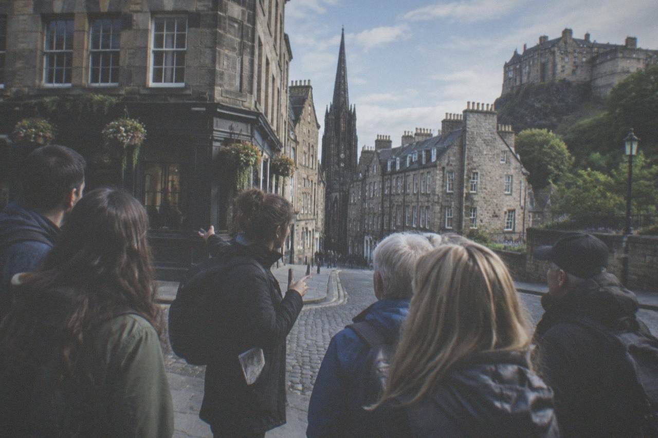 Old Town rooftops and a stone close curving downhill toward Princes Street