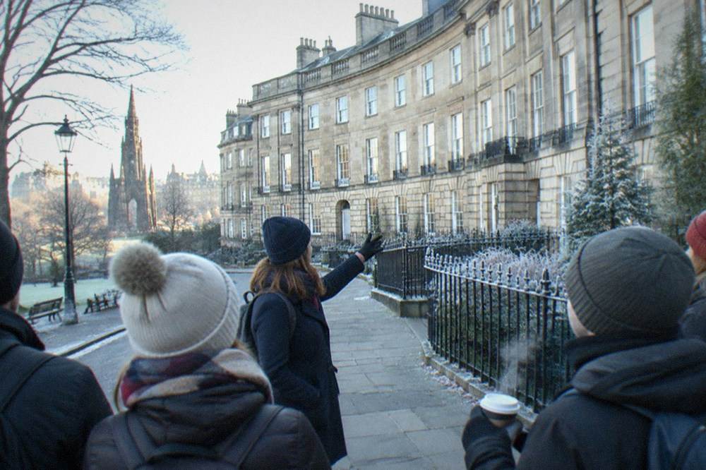 A Georgian crescent facade in Edinburgh New Town with sash windows and stone balustrades