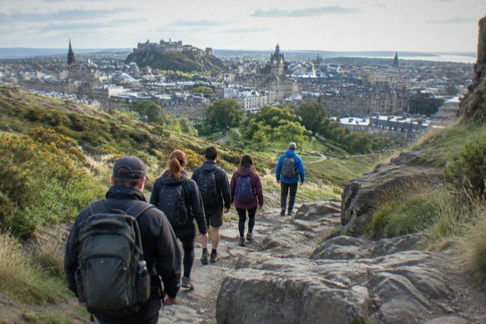 The grassy slopes and rocky summit of Arthur's Seat rising above the lochs of Holyrood Park