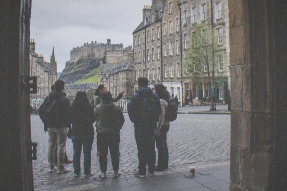 A guide with a small group of visitors on the Royal Mile in Edinburgh