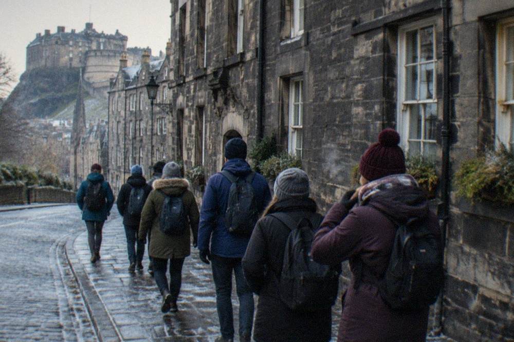 The Royal Mile street in Edinburgh's Old Town with tall stone buildings on both sides