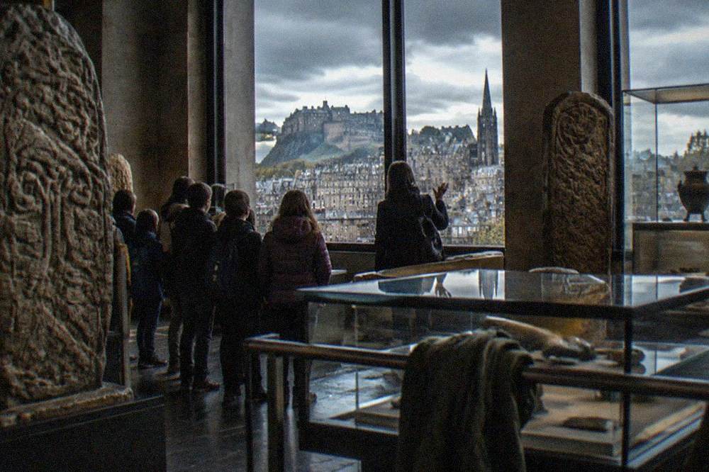 Museum gallery of Scottish history displays with stone carvings and display cases