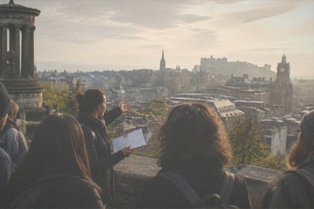 View from Calton Hill across Edinburgh's Old Town rooftops toward the castle in late afternoon light